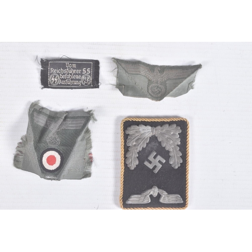 261 - FOUR ITEMS OF THIRD REICH GERMAN UNIFORM INSIGNIA, this lot includes a black and silver officers col... 