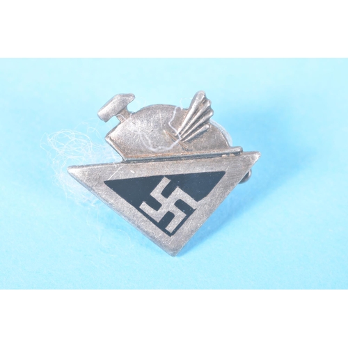 319 - FOUR SMALL GERMAN PIN BADGES AND A STICK PIN, the badges include a white metal swastika pin, a NSV p... 