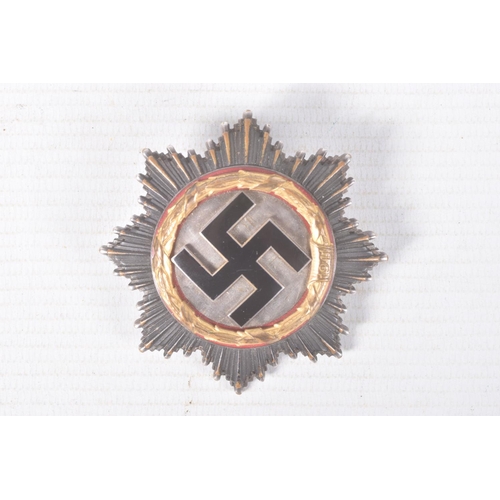 320 - A GERMAN THIRD REICH GOLD ORDER OF THE GERMAN CROSS, this cross is in good condition but shows sign ... 