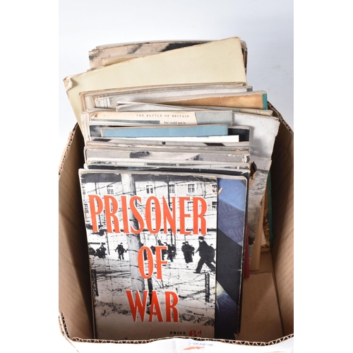 354 - A BOX CONTAINING OVER THIRTY FIVE CAP BADGES, and an assortment soft back magazines relating to WWII... 