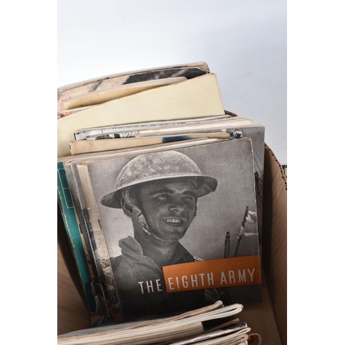 354 - A BOX CONTAINING OVER THIRTY FIVE CAP BADGES, and an assortment soft back magazines relating to WWII... 