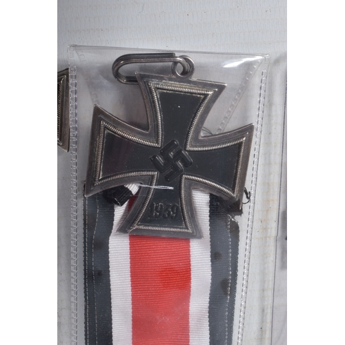 335 - THREE GERMAN IRON CROSSES AND TWO CALSPS, none of the iron crosses have magnetic centres, there are ... 