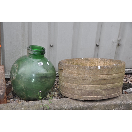 1011 - A MODERN COMPOSITE BARREL EFFECT OVAL PLANTER width 52cm depth 33cm height 24cm and a green glass bo... 