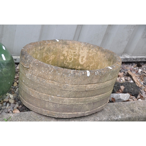 1011 - A MODERN COMPOSITE BARREL EFFECT OVAL PLANTER width 52cm depth 33cm height 24cm and a green glass bo... 