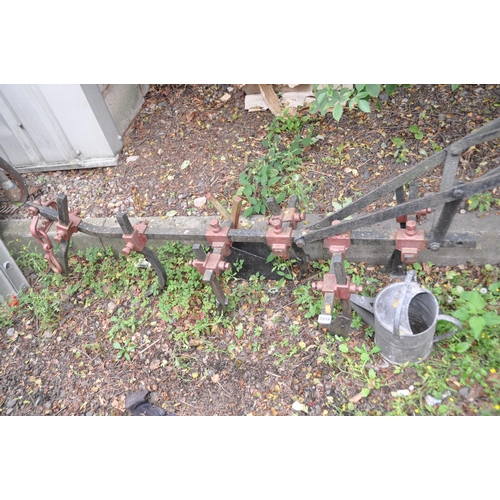 1016 - A VINTAGE WROUGHT AND CAST IRON HORSE DRAWN FURROW with six blades, length 218cm and a galvanised wa... 