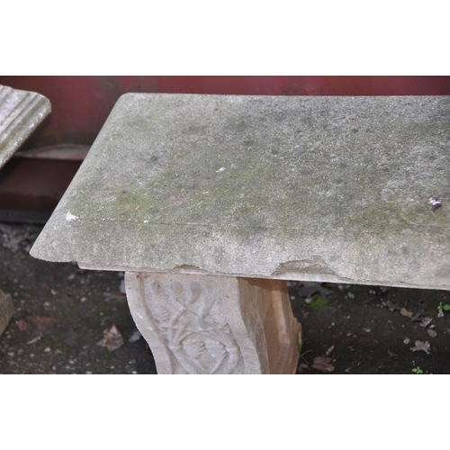 1024 - A MODERN COMPOSITE GARDEN BENCH with shaped supports, vine detailing to front and back, parallel rec... 