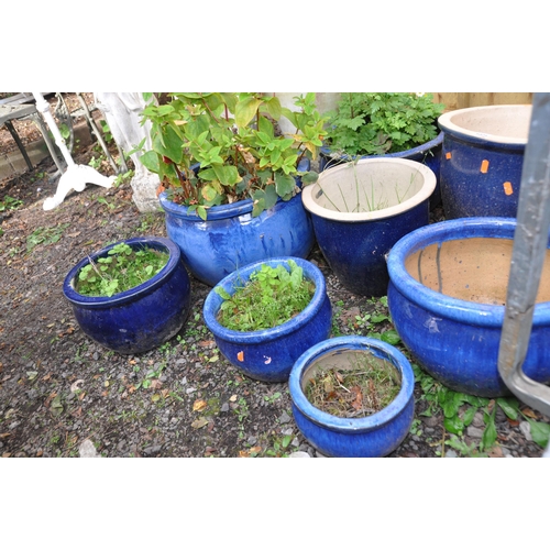 1025 - A COLLECTION OF EIGHT BLUE GLAZED PLANT POTS the largest being 38cm in diameter and 34cm high