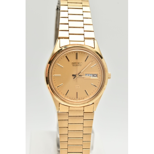 104 - TWO GENTLEMAN'S WRISTWATCHES, to include a Seiko quartz gold coloured stainless steel watch with day... 