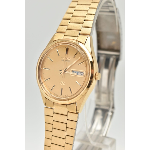 104 - TWO GENTLEMAN'S WRISTWATCHES, to include a Seiko quartz gold coloured stainless steel watch with day... 