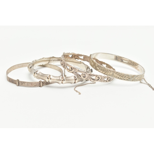 116 - THREE SILVER BANGLES, the first a bamboo style hinged bangle, the second an open work foliage hinged... 