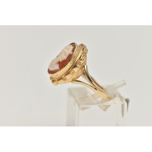 12 - A 9CT GOLD CAMEO RING, carved shell cameo, collet set within a fine rope twist and scallop surround,... 