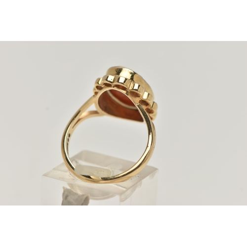 12 - A 9CT GOLD CAMEO RING, carved shell cameo, collet set within a fine rope twist and scallop surround,... 