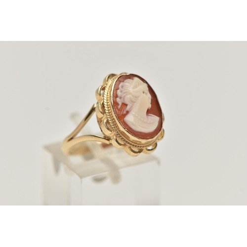 12 - A 9CT GOLD CAMEO RING, carved shell cameo, collet set within a fine rope twist and scallop surround,... 