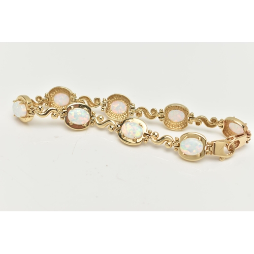 2 - A YELLOW METAL, SYNTHETIC OPAL LINE BRACELET, designed as a series of eight synthetic opal cabochons... 