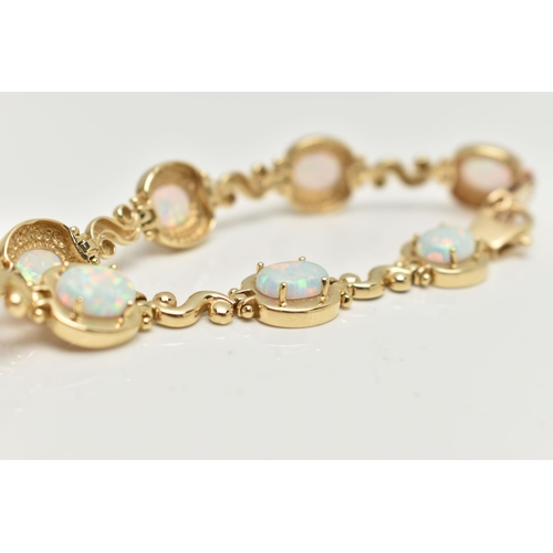 2 - A YELLOW METAL, SYNTHETIC OPAL LINE BRACELET, designed as a series of eight synthetic opal cabochons... 