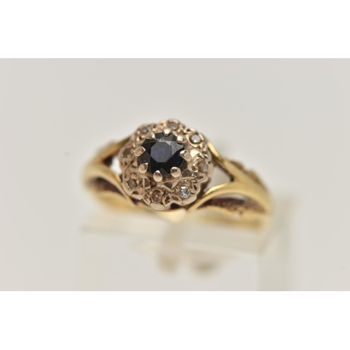 36 - AN 18CT GOLD SAPPHIRE AND DIAMOND CLUSTER RING, designed as a central circular sapphire within a sin... 