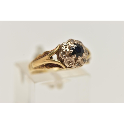 36 - AN 18CT GOLD SAPPHIRE AND DIAMOND CLUSTER RING, designed as a central circular sapphire within a sin... 