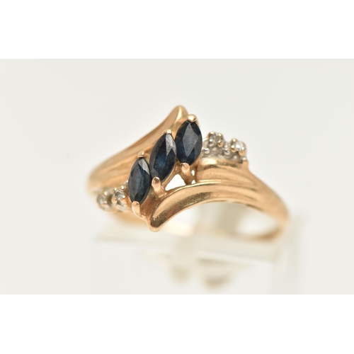 58 - A YELLOW METAL GEM SET RING, asymmetrical design set with three marquise cut blue sapphires, and fou... 