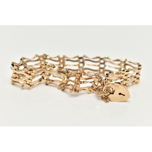 7 - A 9CT GOLD GATE BRACELET, five bar gate bracelet fitted with a heart padlock clasp, with additional ... 