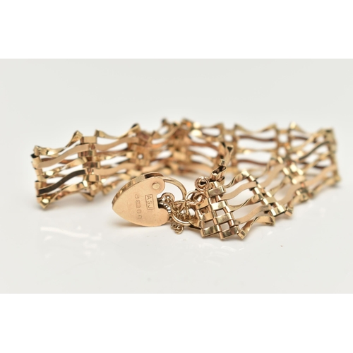 7 - A 9CT GOLD GATE BRACELET, five bar gate bracelet fitted with a heart padlock clasp, with additional ... 