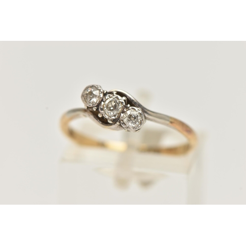 73 - A YELLOW METAL THREE STONE DIAMOND RING, asymmetrical row of three old cut diamonds, white metal mou... 