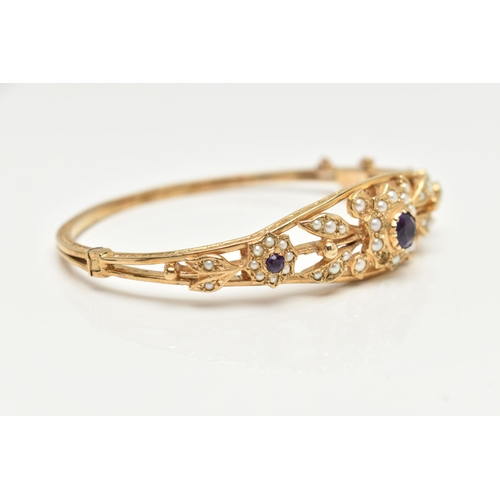 75 - A 9CT GOLD AMETHYST AND SEED PEARL HINGED BANGLE, floral pattern bangle set with three circular cut ... 