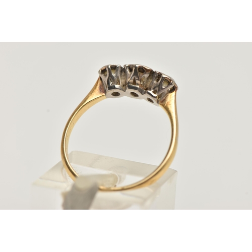 77 - A YELLOW METAL THREE STONE DIAMOND RING, round brilliant cut diamond to the centre, flanked with two... 