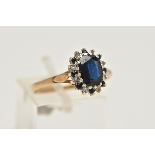 86 - A 9CT GOLD SAPPHIRE CLUSTER RING, oval cut sapphire, prong set with alternating sapphires and single... 