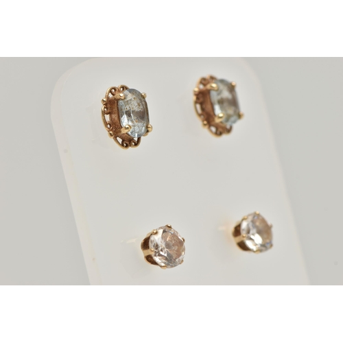 89 - TWO PAIRS OF EAR STUDS, the first designed as an oval blue topaz within a four claw setting with a s... 