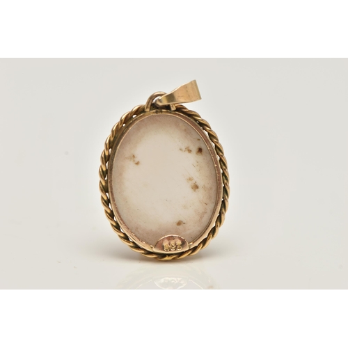 90 - A CARVED CAMEO PENDANT, the oval conch shell carved to depict a male soldier in profile within a rop... 