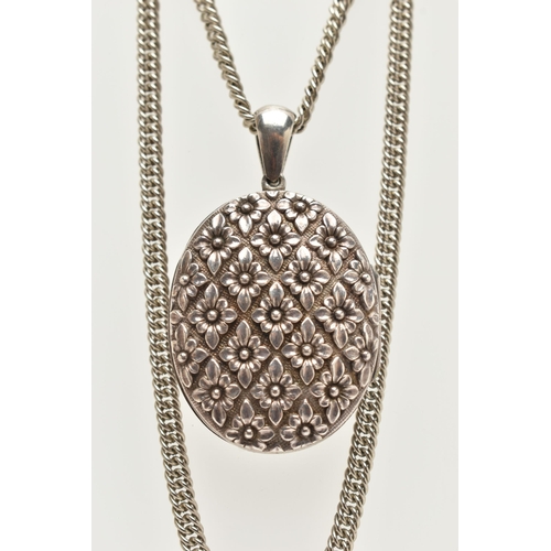 94 - AN OVAL LOCKET, with floral decoration suspended from a curb link chain, length of locket 55mm, leng... 