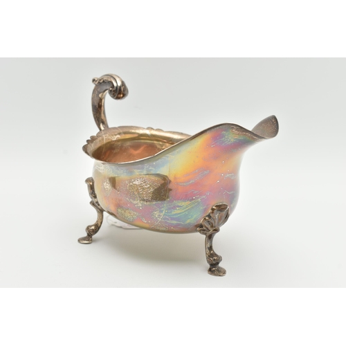 152 - A GEORGE V SILVER SAUCE BOAT, wavy rim S scroll handle on four cabriole legs with hoof feet and shel... 