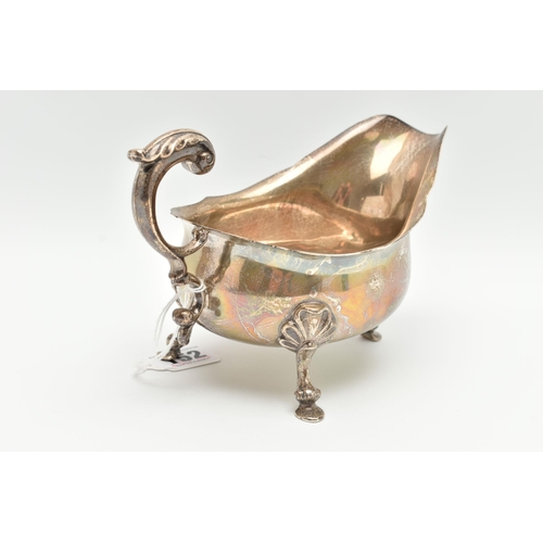 152 - A GEORGE V SILVER SAUCE BOAT, wavy rim S scroll handle on four cabriole legs with hoof feet and shel... 