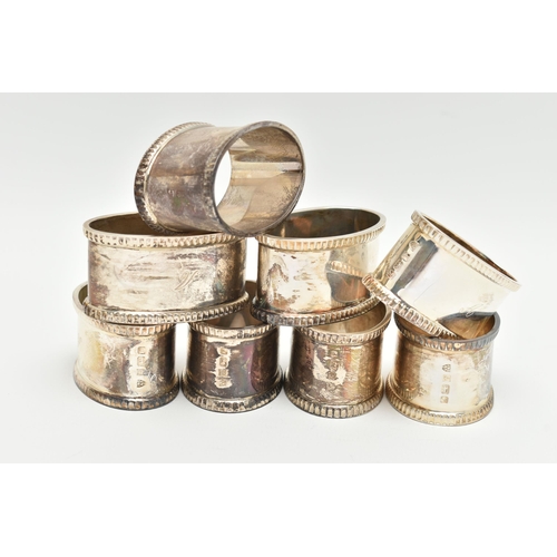 153 - A SET OF EIGHT ELIZABETH II OVAL SILVER NAPKIN RINGS, fluted rims, all engraved with initial 'A', ma... 