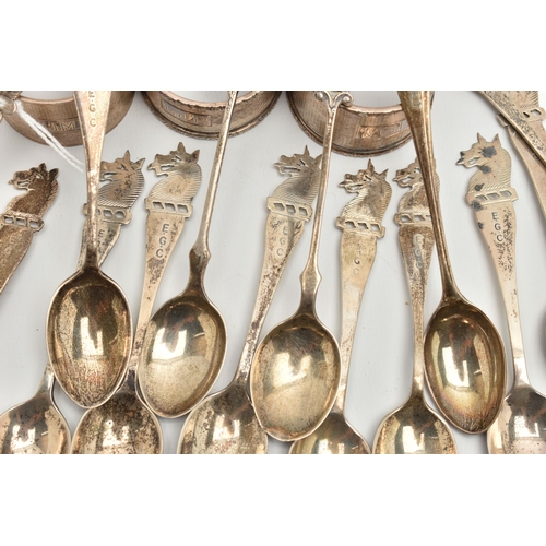 166 - A PARCEL OF SILVER GOLFING TEASPOONS AND THREE ELIZABETH II CIRCULAR SILVER NAPKIN RINGS, the teaspo... 