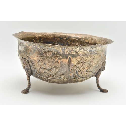 173 - A LATE VICTORIAN SILVER BOWL, with wavy rim, repoussé decorated with foliate scrolls, birds and beas... 