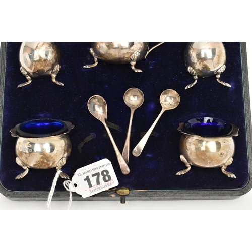 178 - A CASED GEORGE V SILVER FIVE PIECE CRUET SET AND THREE CONDIMENT SPOONS, the cruet set comprising a ... 