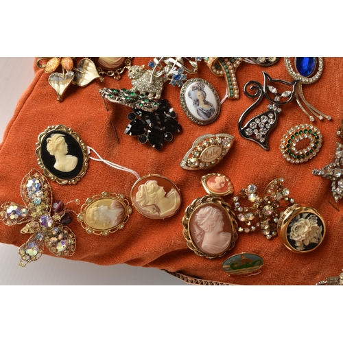 222 - A BOX OF COSTUME JEWELLERY, to include an orange cushion pinned with various brooches, together with... 