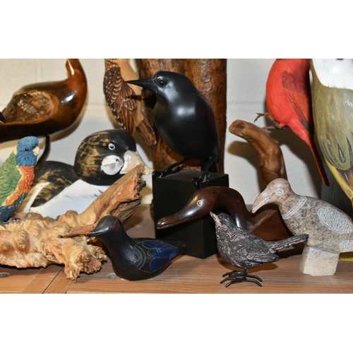 397 - A COLLECTION OF BIRD SCULPTURES, twenty birds to include two woodpeckers attached to logs, a wooden ... 