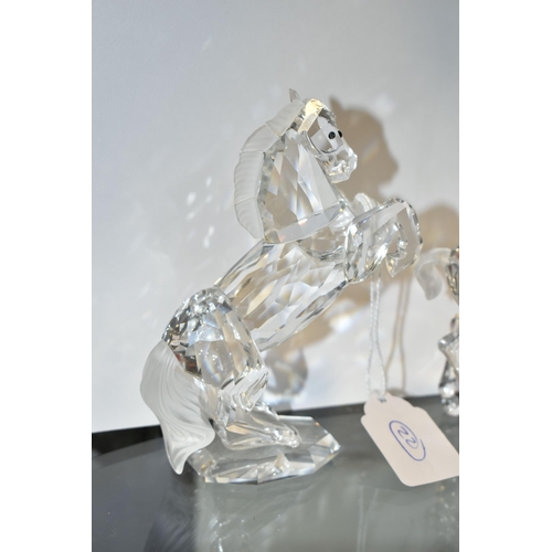 406 - TWO BOXED SWAROVSKI CRYSTAL SCULPTURES OF HORSES, comprising a Foals Clear figure group no 627637, f... 