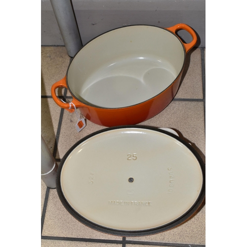 428 - THREE PIECES OF LE CREUSET COOKWARE, comprising an oval cast iron covered casserole dish, size 25, a... 