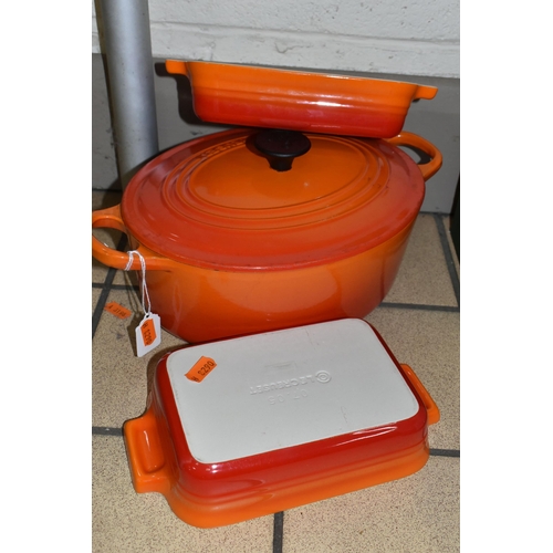 428 - THREE PIECES OF LE CREUSET COOKWARE, comprising an oval cast iron covered casserole dish, size 25, a... 