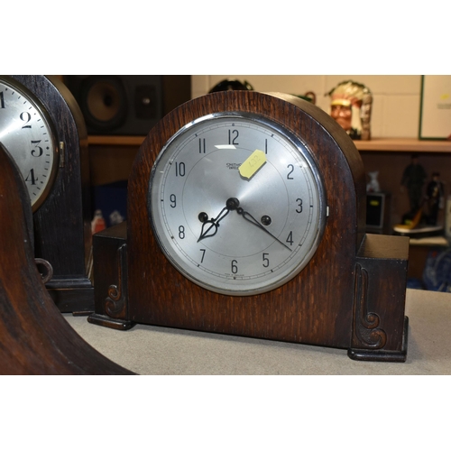 432 - THREE OAK CASED MANTEL CLOCKS, eight day striking, one clock has maker's mark Smiths Enfield, two ke... 