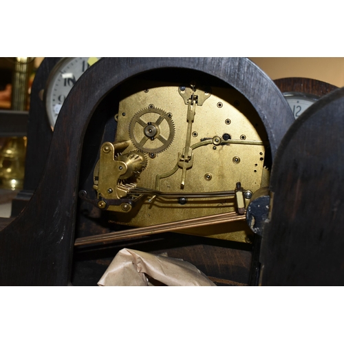 432 - THREE OAK CASED MANTEL CLOCKS, eight day striking, one clock has maker's mark Smiths Enfield, two ke... 