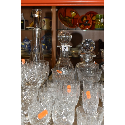 434 - A QUANTITY OF GLASSWARE, comprising three decanters, a set of six cut glass wine glasses, a small de... 