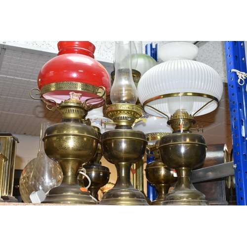 442 - A GROUP OF EIGHT VICTORIAN OIL LAMPS, mainly brass and metal bases, assorted coloured glass shades (... 