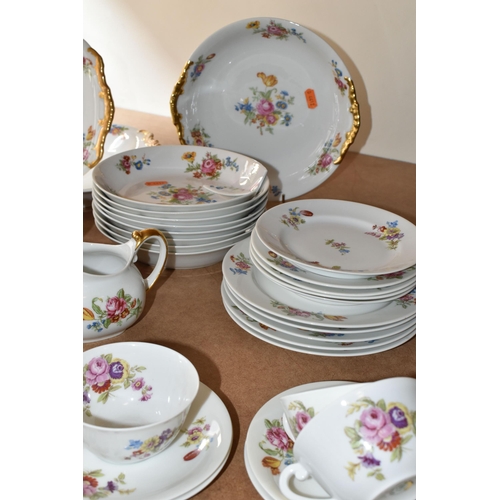 510 - LIMOGES DINNER SET, transfer print floral design on a white ground, gold gilt handles, comprising tw... 