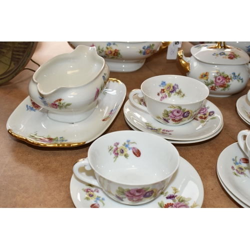 510 - LIMOGES DINNER SET, transfer print floral design on a white ground, gold gilt handles, comprising tw... 