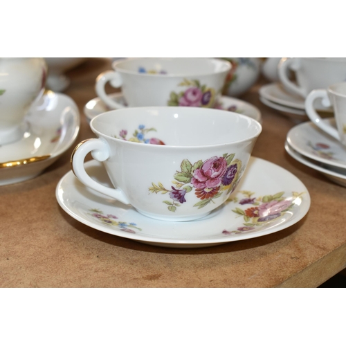 510 - LIMOGES DINNER SET, transfer print floral design on a white ground, gold gilt handles, comprising tw... 