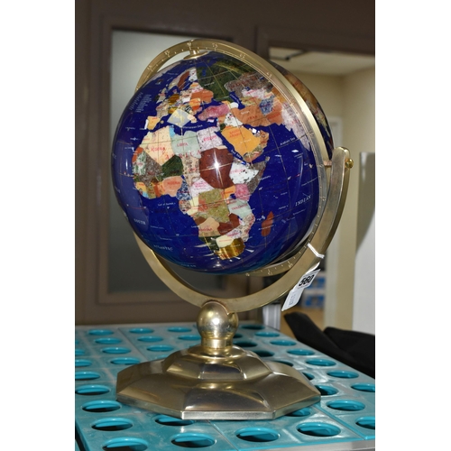 560 - A MODERN TABLE TOP TERRESTRIAL GLOBE, mounted in a brass gimbal stand / frame, height 36cm